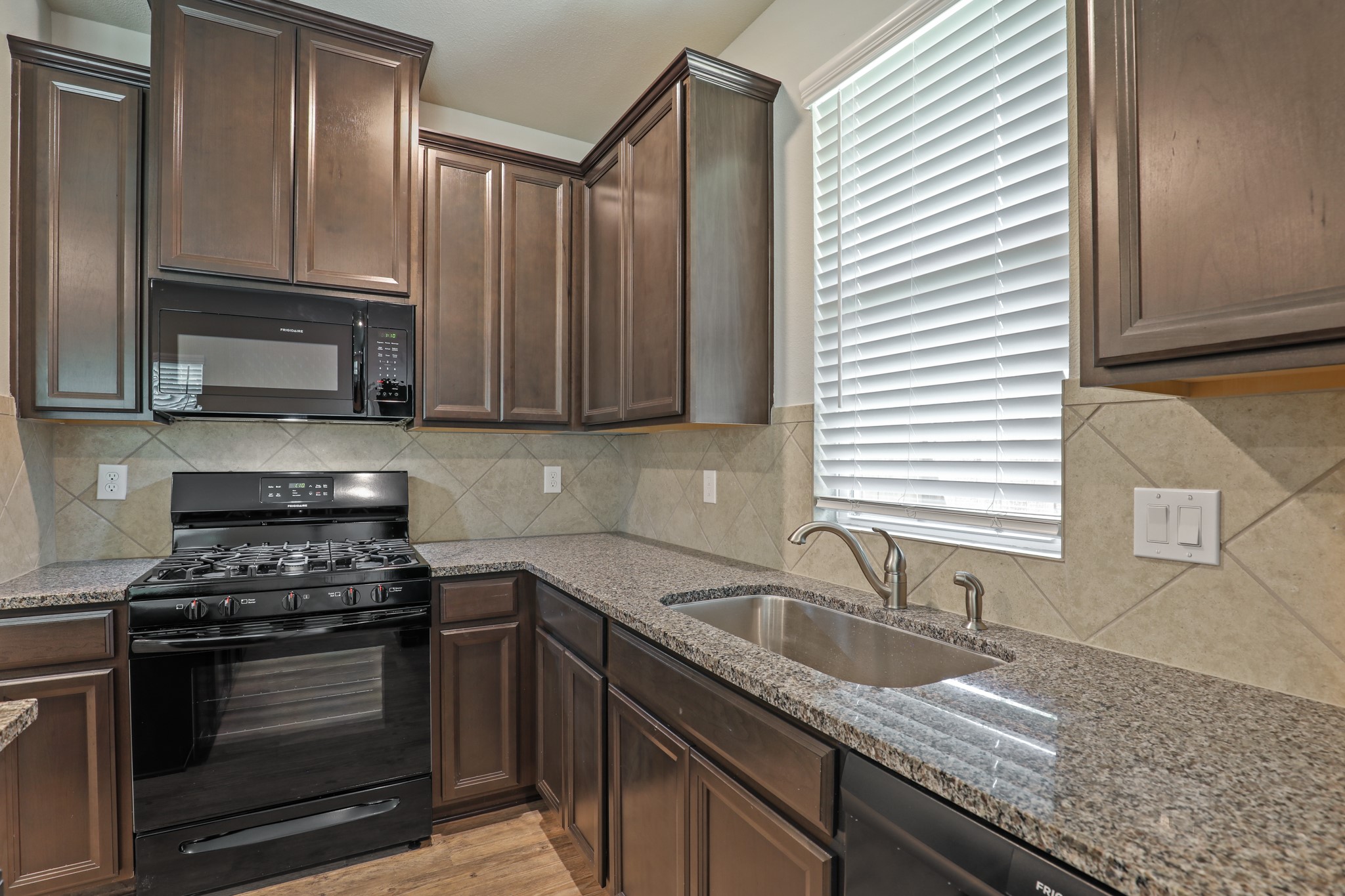 13502 Axel Lane Houston, TX 77047 - Photo 14 of 34 a kitchen with granite countertop stainless steel appliances a sink a stove and cabinets