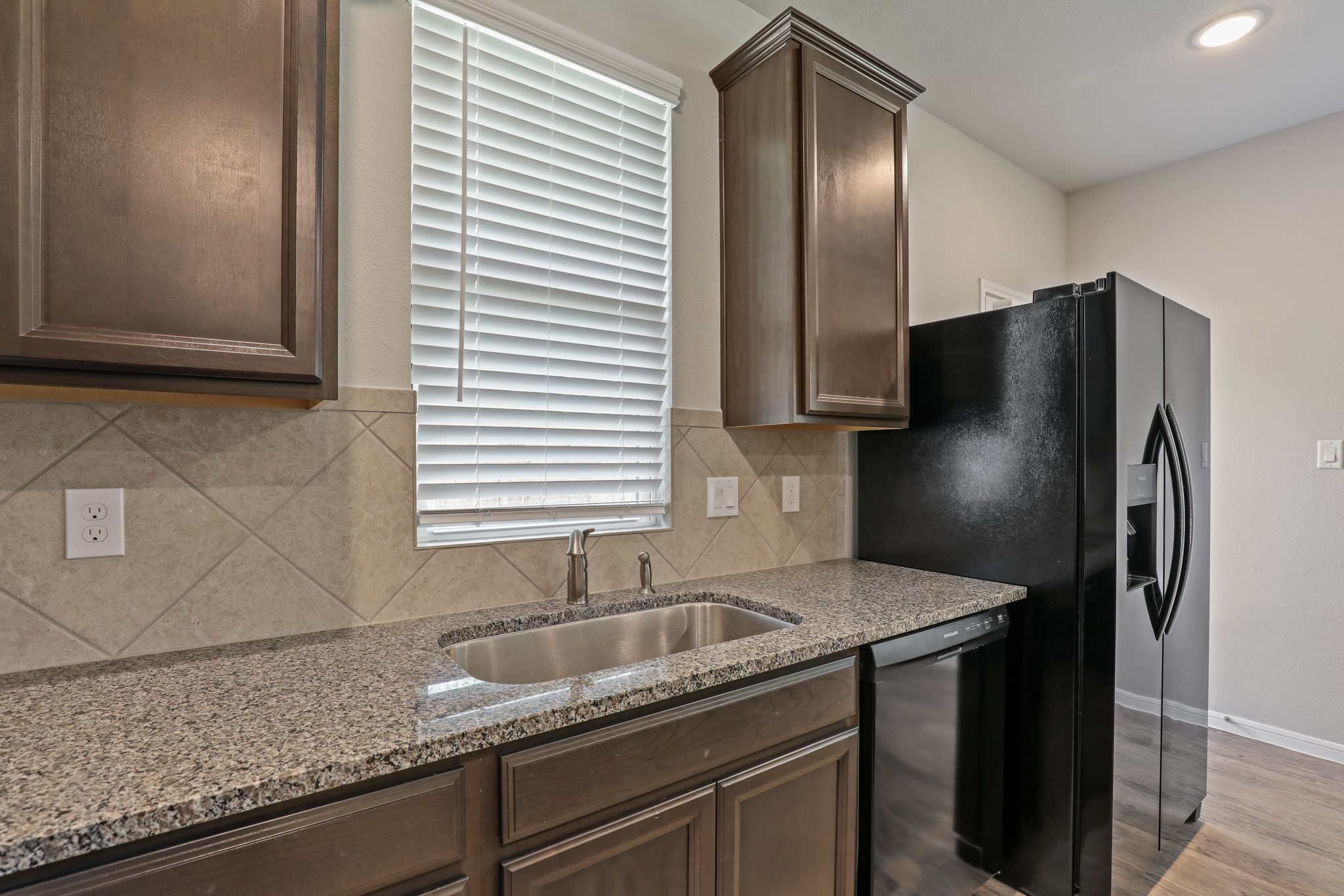 13502 Axel Lane Houston, TX 77047 - Photo 15 of 34 a kitchen with granite countertop a refrigerator and a sink