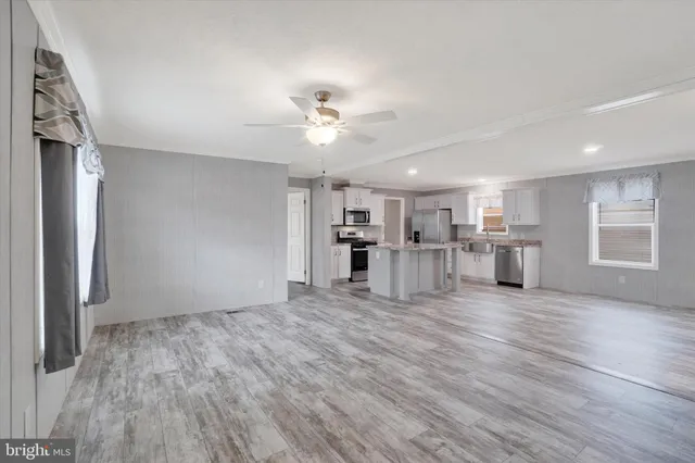 a view of a kitchen with wooden floor and a kitchen space