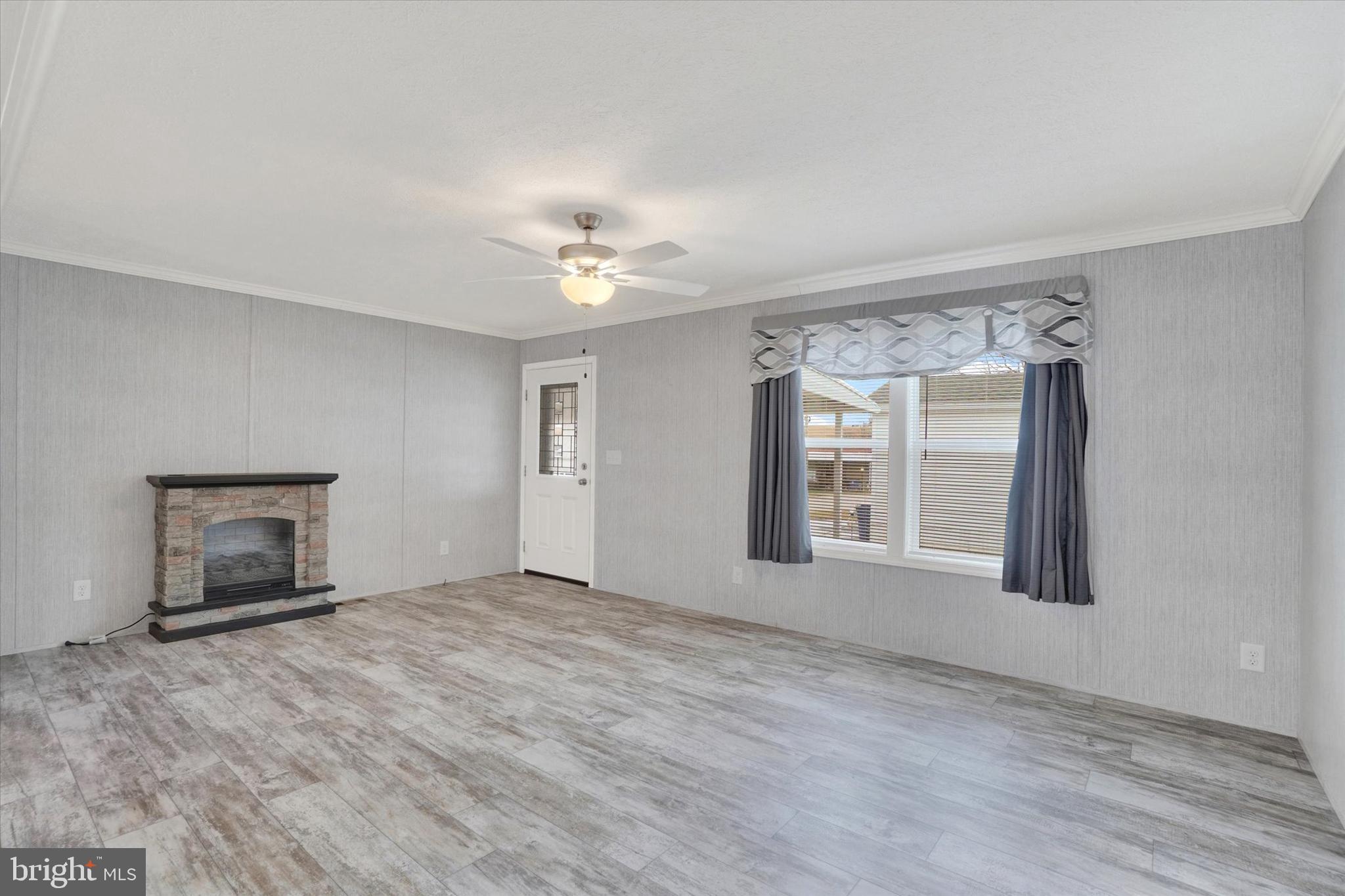 208 Country Ridge Drive York, PA 17408 - Photo 4 of 26 a view of an empty room with a fireplace and a window