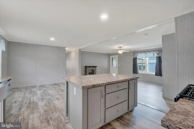 a kitchen with a sink a window and stainless steel appliances