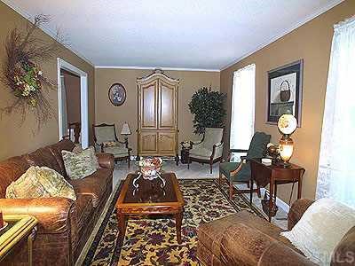 1412 Kingston Ridge Road Cary, NC 27511 - Photo 1 of 1 a living room with furniture and a large window