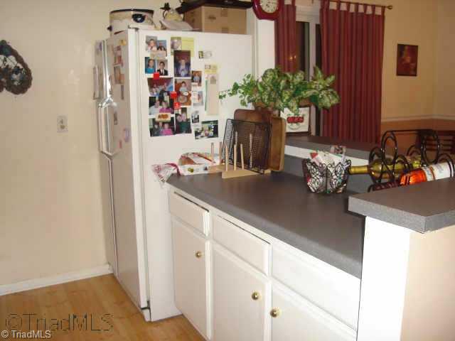 5733 H Bramblegate Road, Unit H Greensboro, NC 27409 - Photo 5 of 9 Other. Kitchen features bar space and is open to dining room.