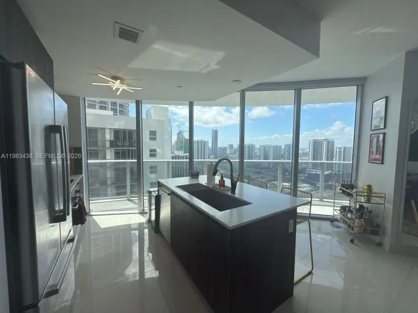 a dining room with stainless steel appliances a table and chairs
