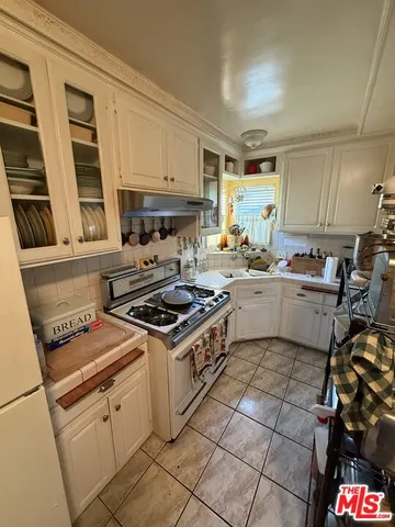 a kitchen with a stove a sink and a refrigerator