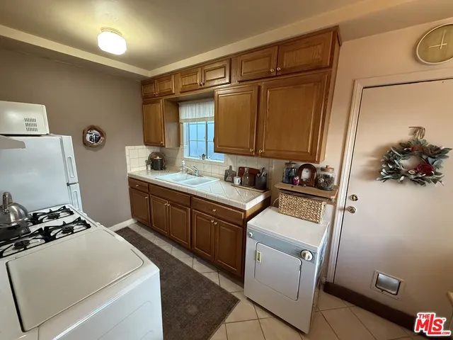 a room with a sink and a washer dryer