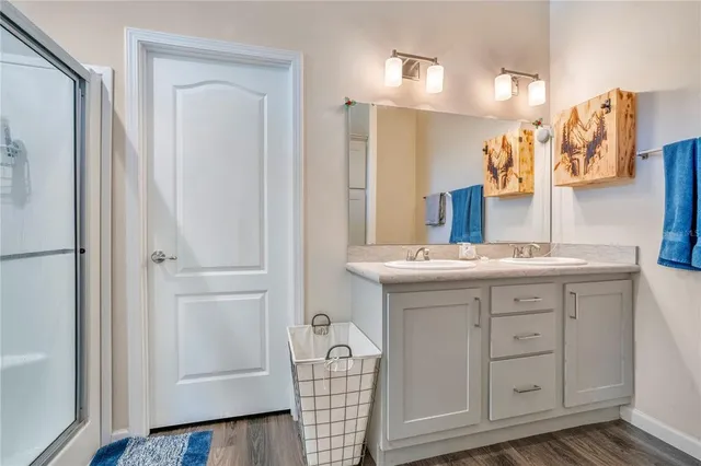 a bathroom with a sink double vanity and a mirror