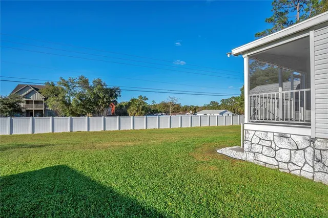 a view of yard with swimming pool and green space