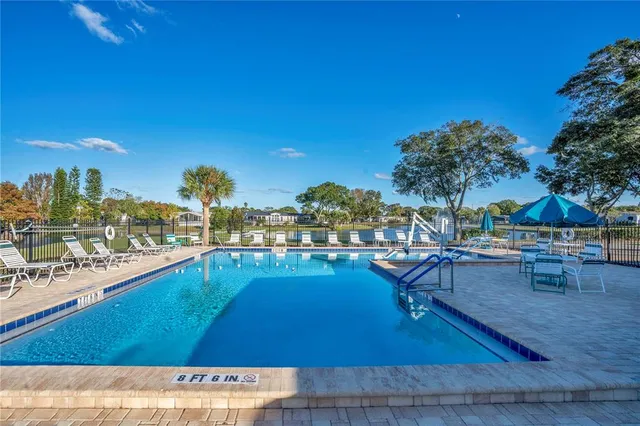 a view of swimming pool with outdoor seating and plants