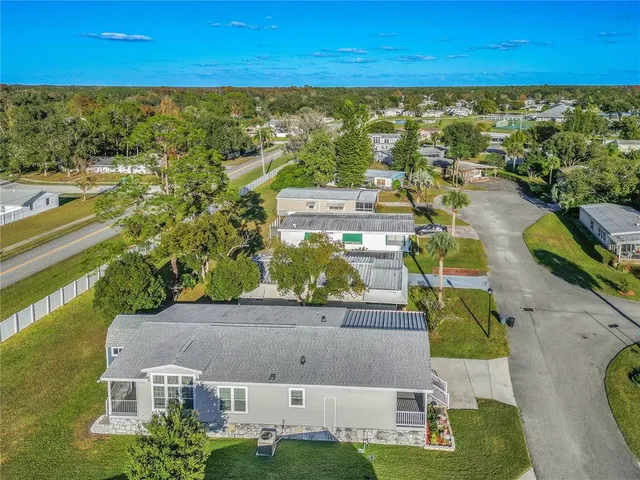 an aerial view of residential houses with outdoor space and swimming pool