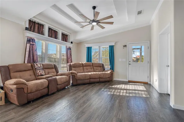 a living room with furniture and a wooden floor
