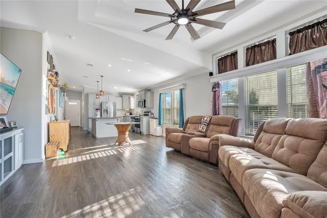 a living room with furniture and a floor to ceiling window