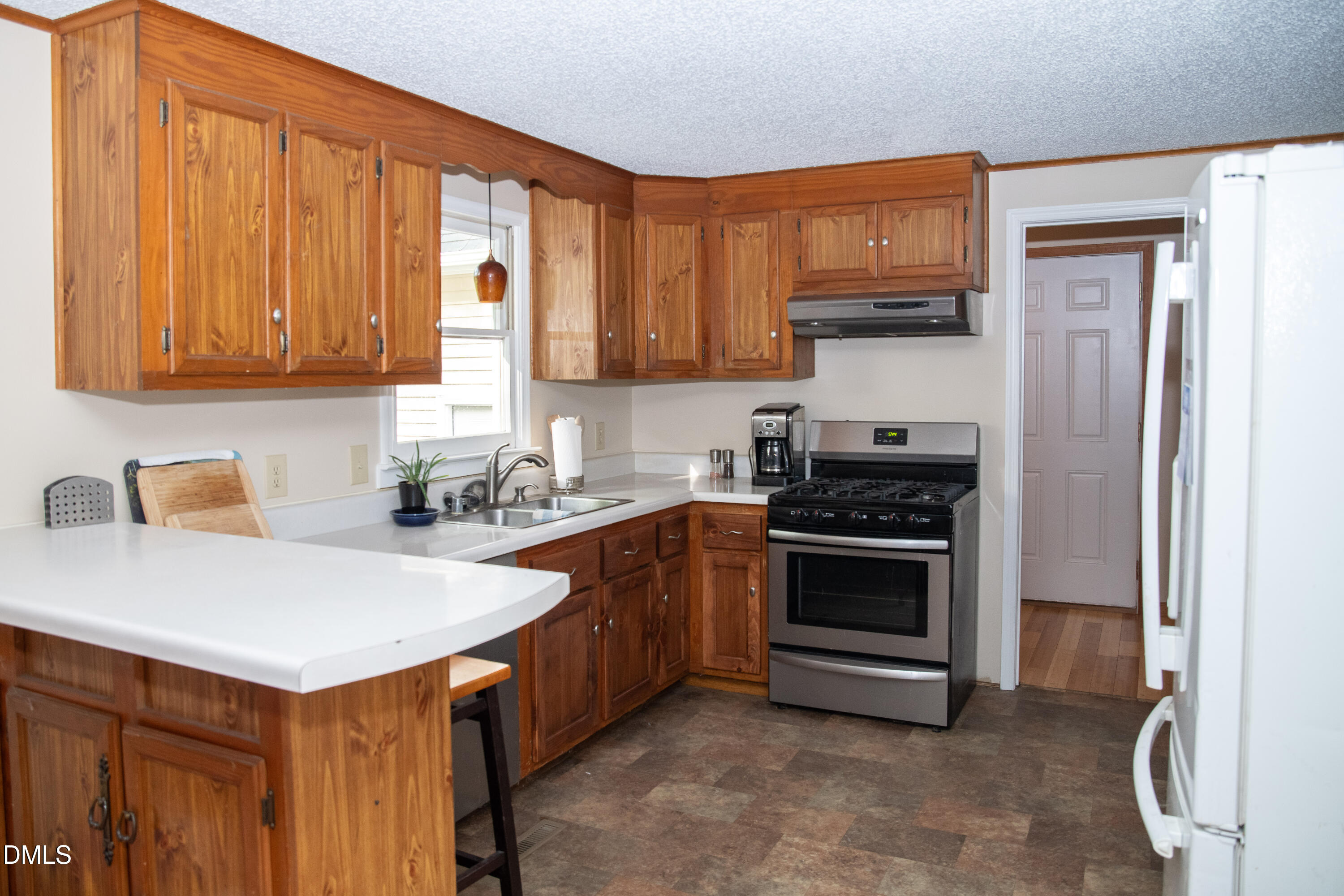 230 Hillsborough Road Timberlake, NC 27583 - Photo 7 of 15 a kitchen with granite countertop a sink stainless steel appliances and cabinets