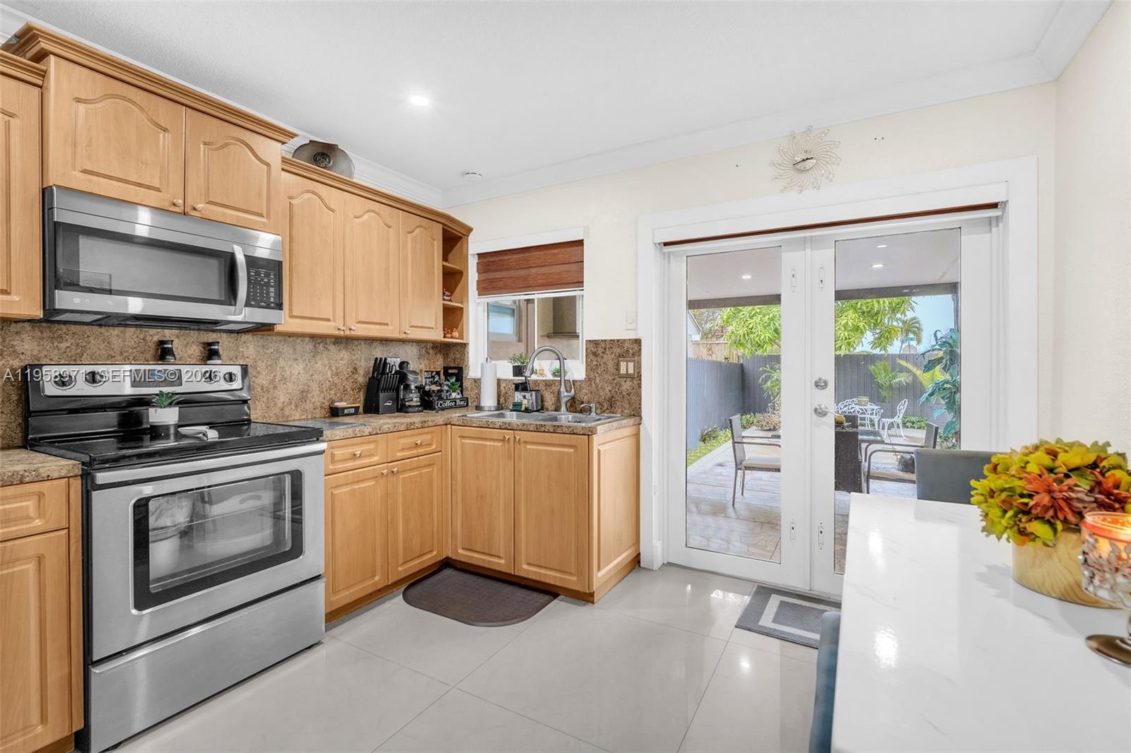 11245 Southwest 155th Lane Miami, FL 33157 - Photo 13 of 30 a kitchen with stainless steel appliances granite countertop a stove a sink and a microwave