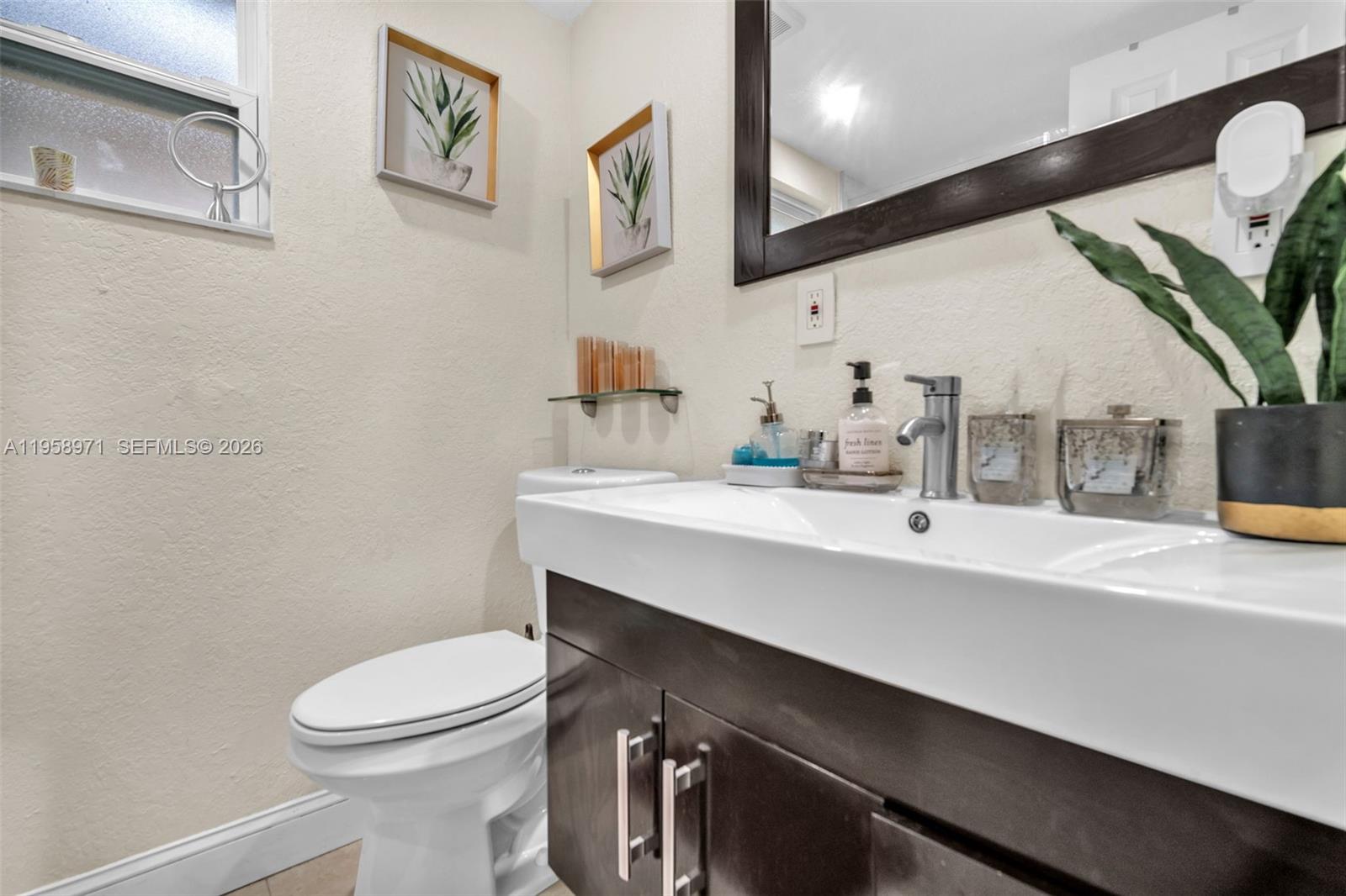 11245 Southwest 155th Lane Miami, FL 33157 - Photo 16 of 30 a bathroom with a sink a toilet and mirror