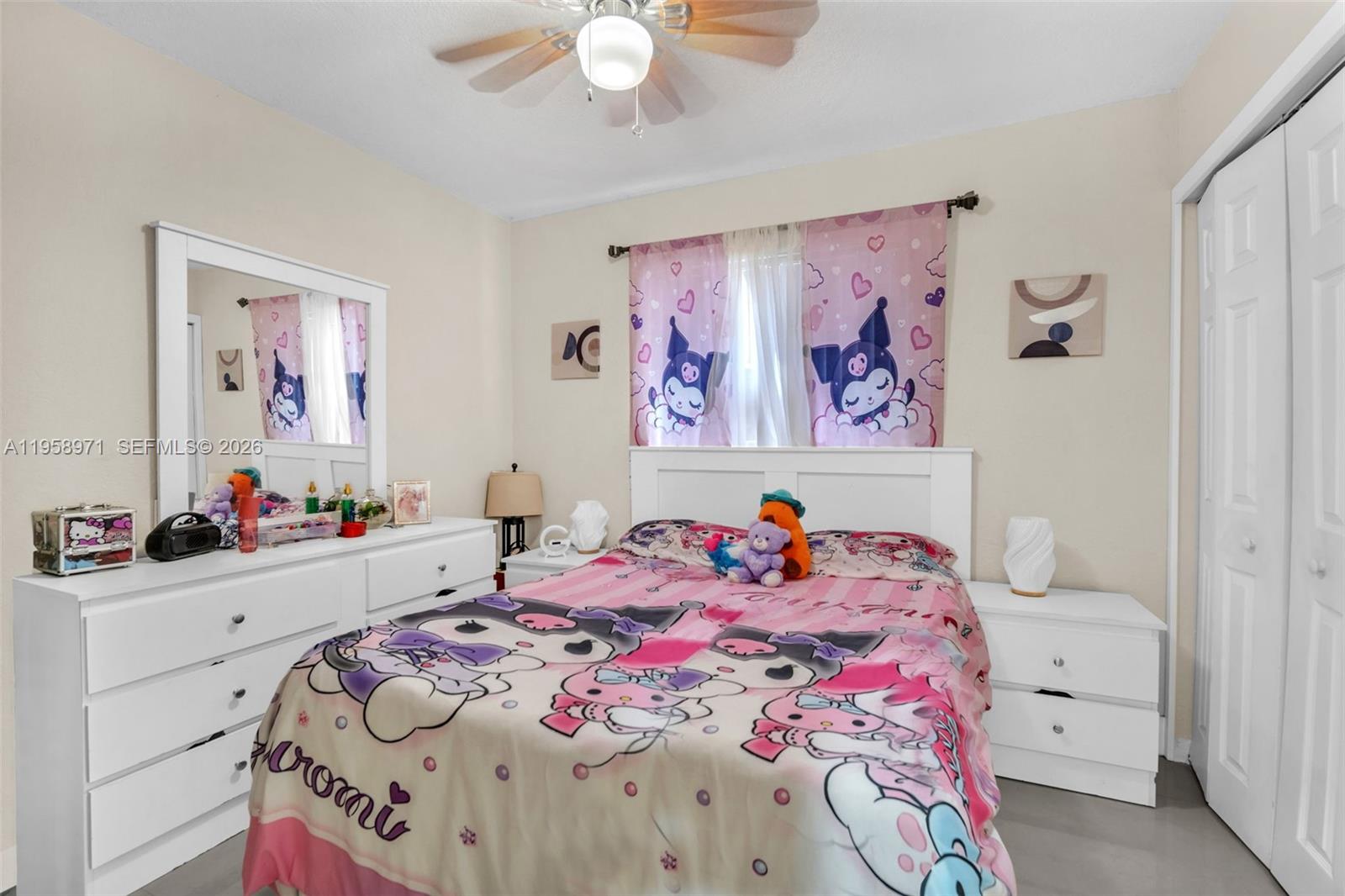 11245 Southwest 155th Lane Miami, FL 33157 - Photo 17 of 30 a bedroom with a bed a chandelier and a dresser