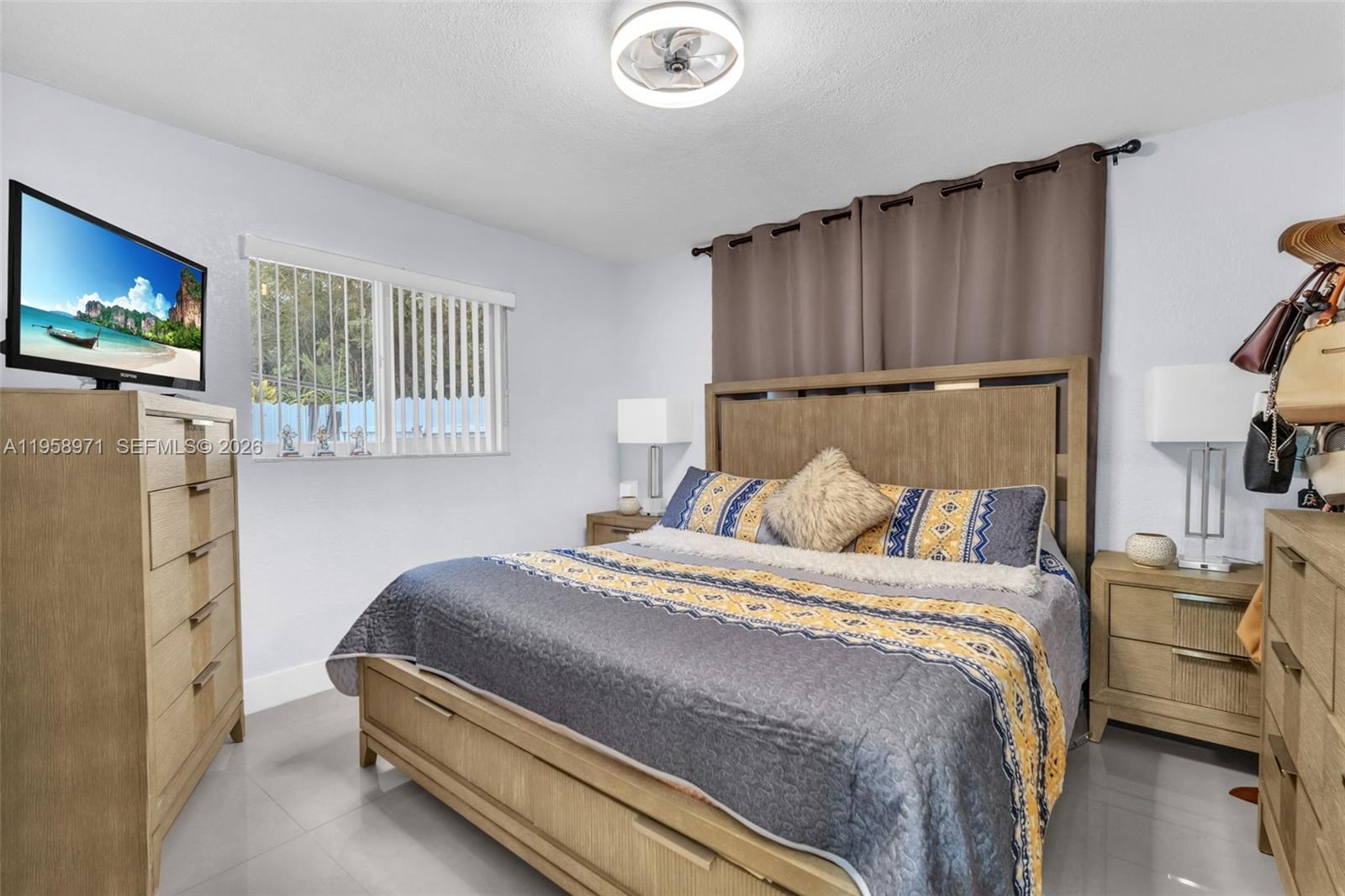 11245 Southwest 155th Lane Miami, FL 33157 - Photo 18 of 30 a bedroom with a bed and a flat screen tv
