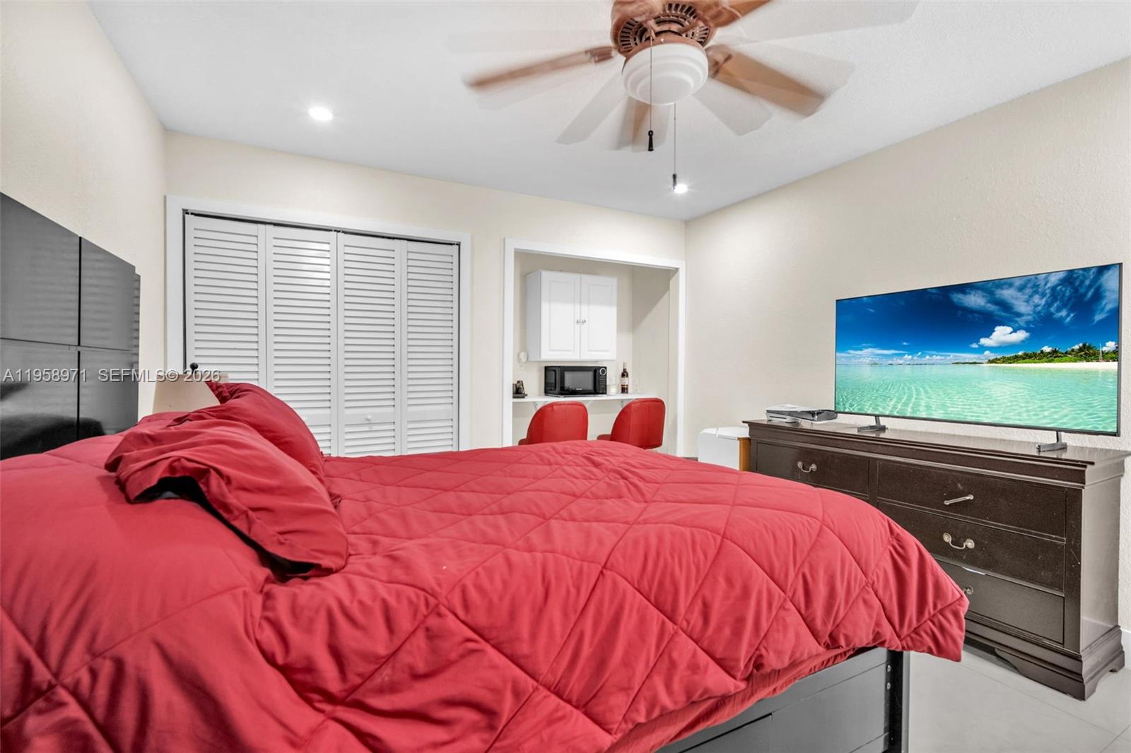 11245 Southwest 155th Lane Miami, FL 33157 - Photo 19 of 30 a bedroom with a bed and a flat screen tv