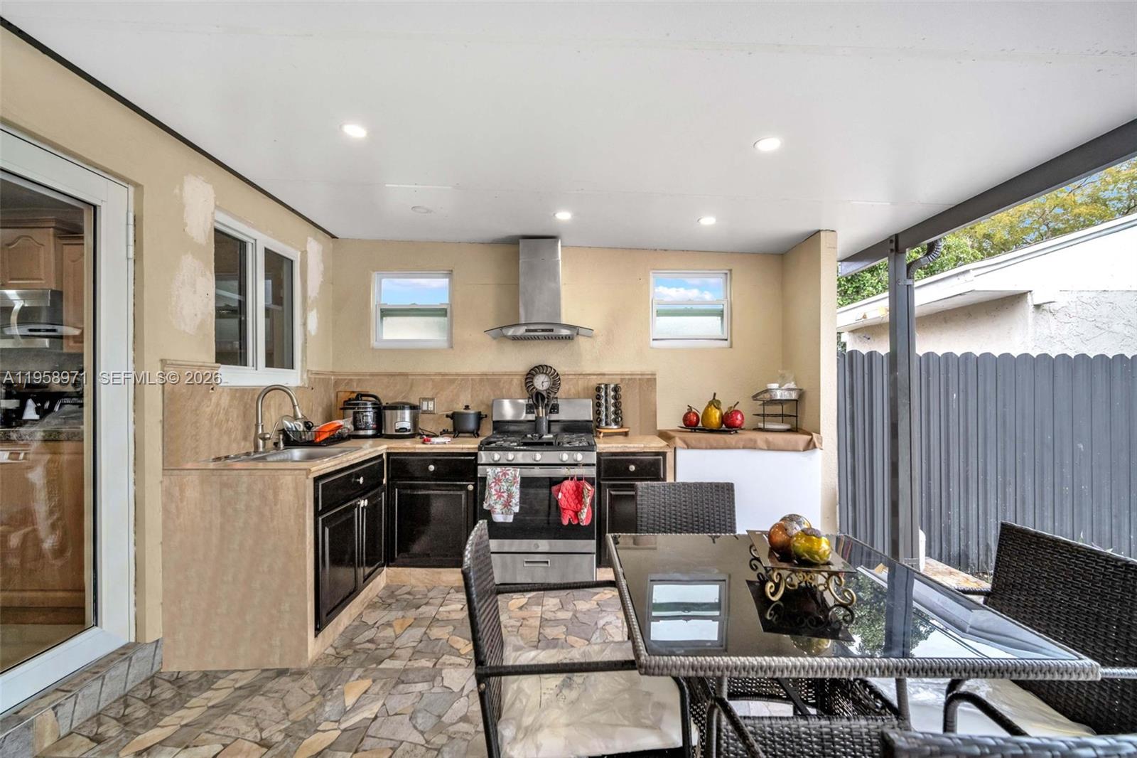 11245 Southwest 155th Lane Miami, FL 33157 - Photo 28 of 30 a kitchen with stainless steel appliances kitchen island granite countertop a refrigerator and sink