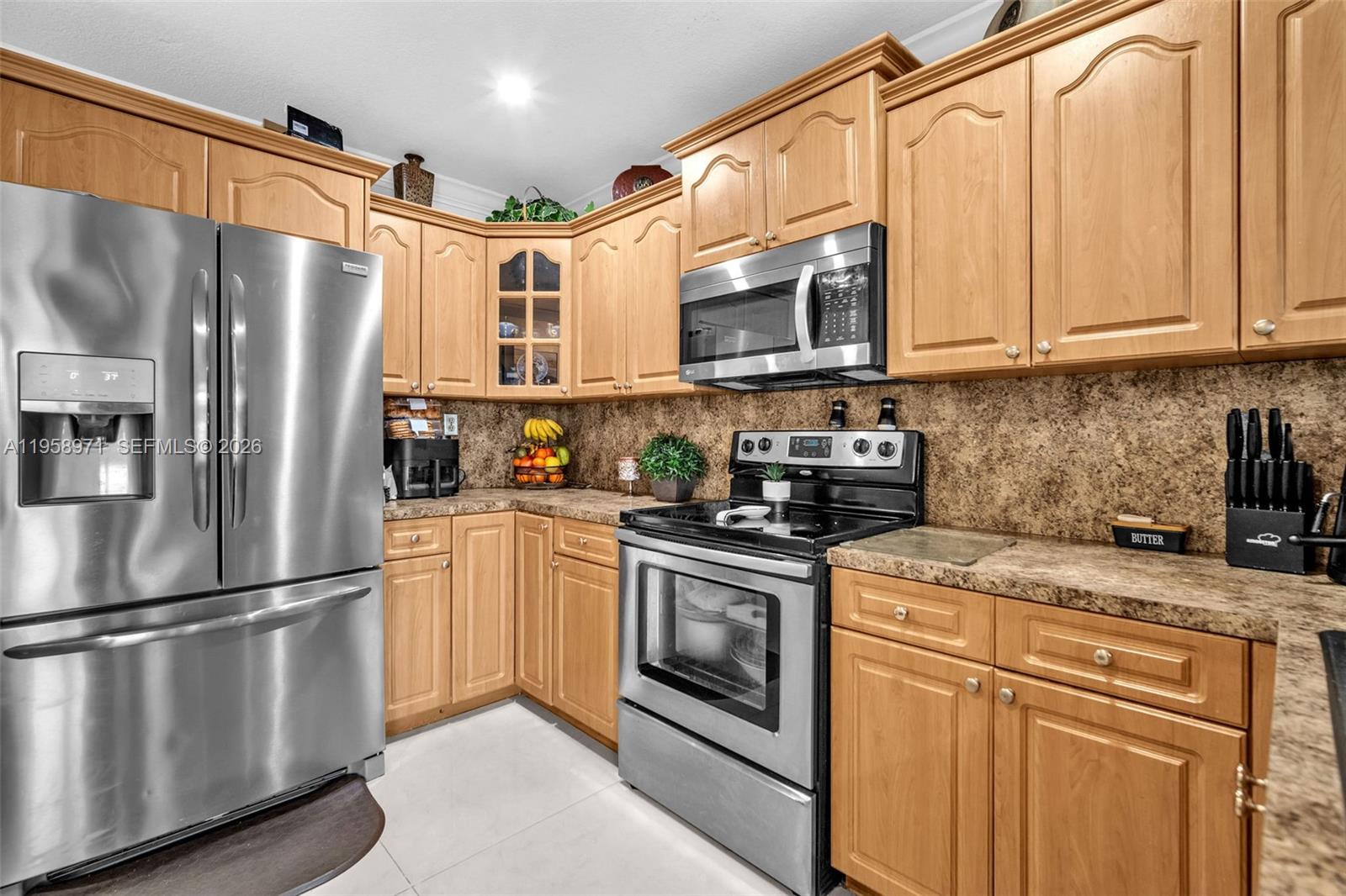 11245 Southwest 155th Lane Miami, FL 33157 - Photo 10 of 30 a kitchen with stainless steel appliances granite countertop a refrigerator stove a sink and dishwasher with white cabinets