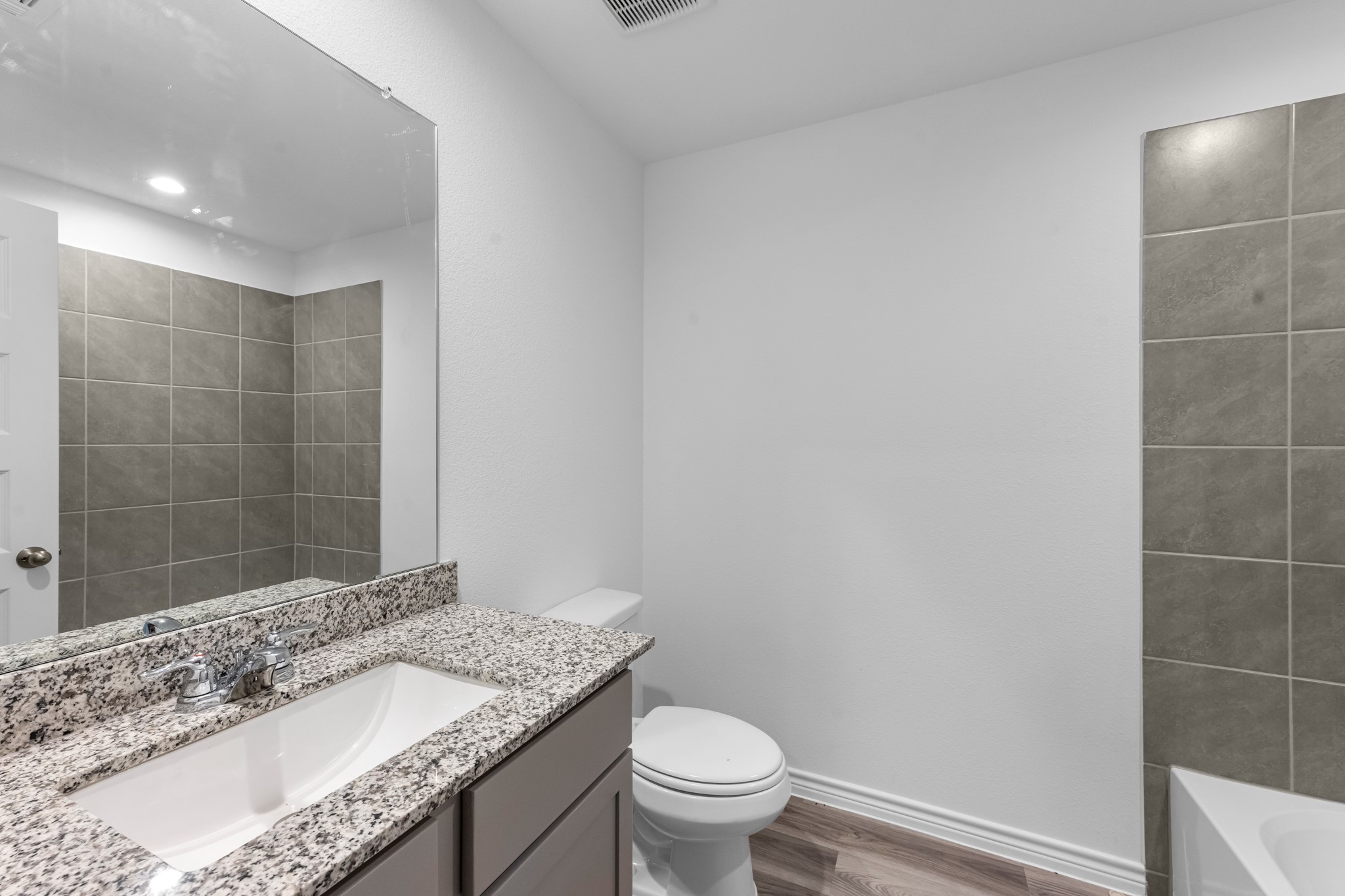 5650 Spoonbill Orange, TX 77632 - Photo 18 of 26 a bathroom with a granite countertop sink a toilet and shower