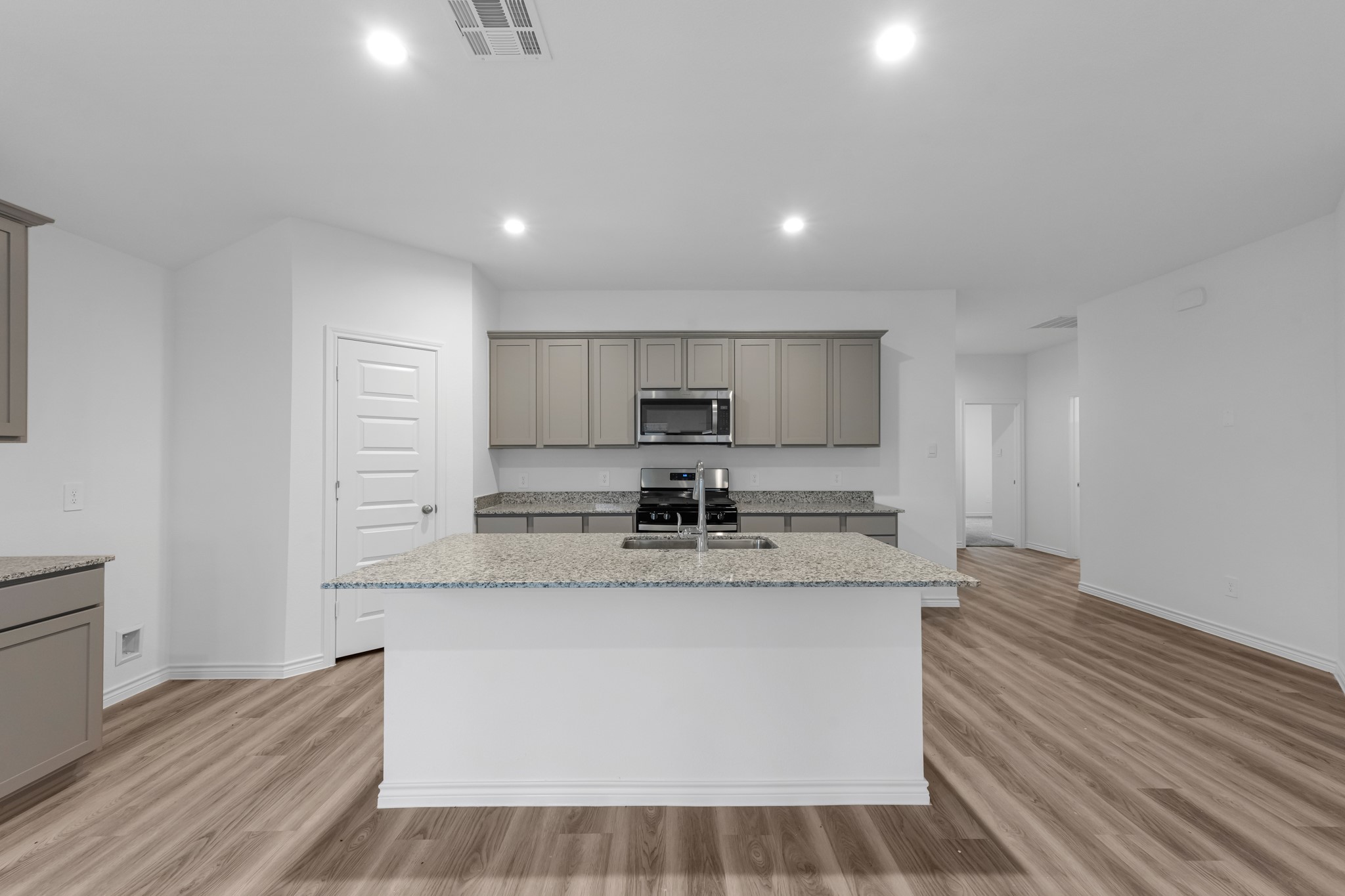 5650 Spoonbill Orange, TX 77632 - Photo 2 of 26 a large kitchen with stainless steel appliances granite countertop a stove a sink and a refrigerator