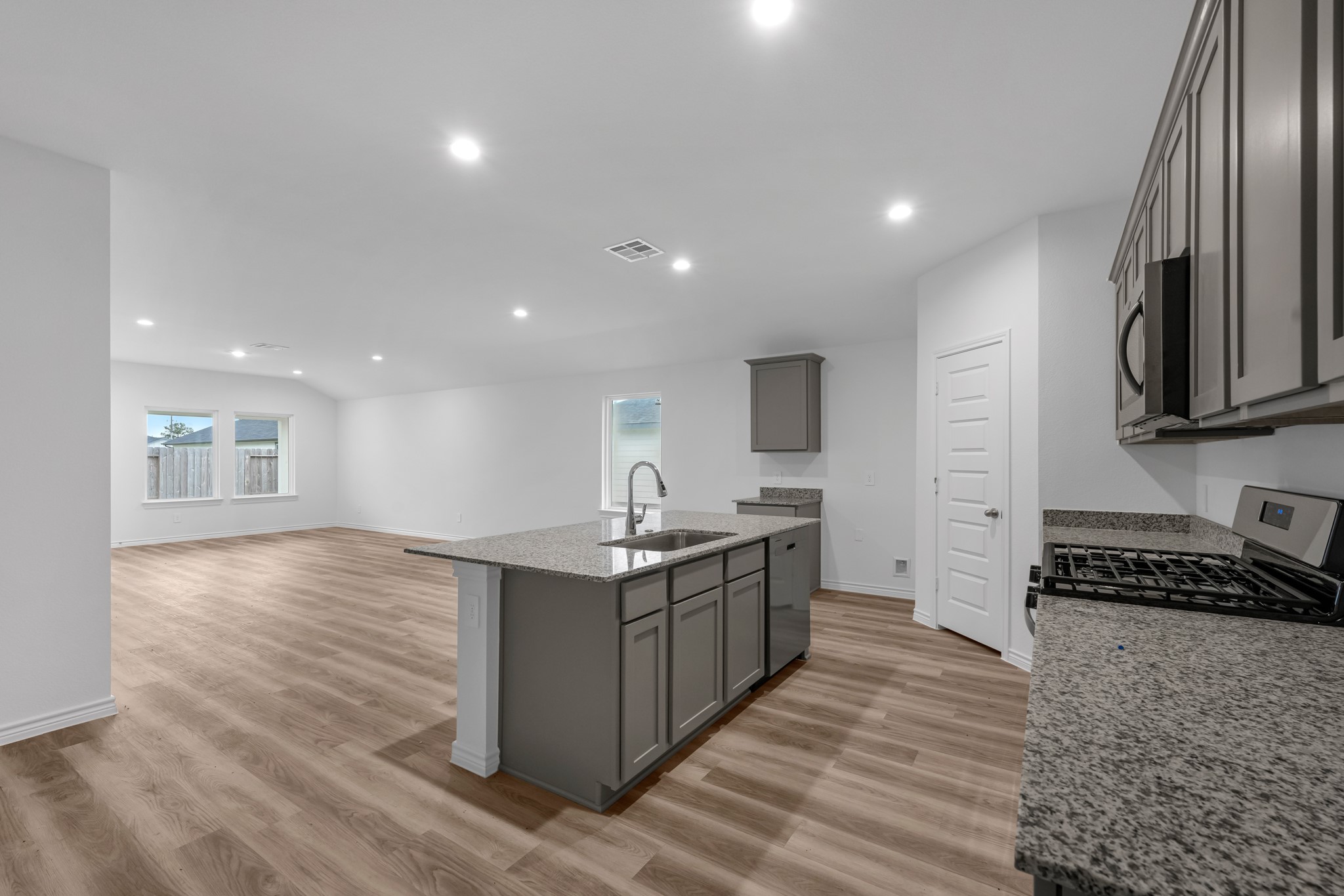 5650 Spoonbill Orange, TX 77632 - Photo 4 of 26 a kitchen with stainless steel appliances granite countertop a stove a sink and a refrigerator