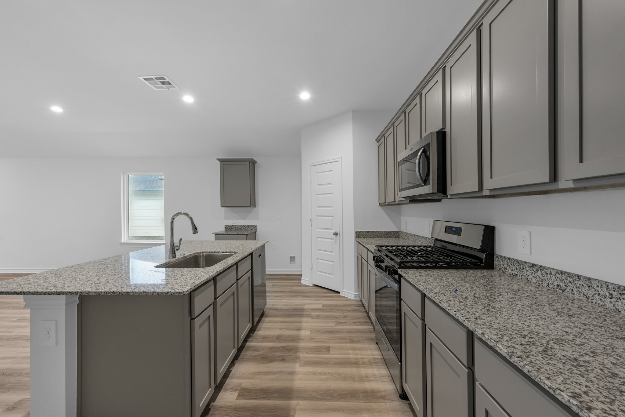 5650 Spoonbill Orange, TX 77632 - Photo 5 of 26 a kitchen with stainless steel appliances granite countertop a stove top oven a sink and dishwasher