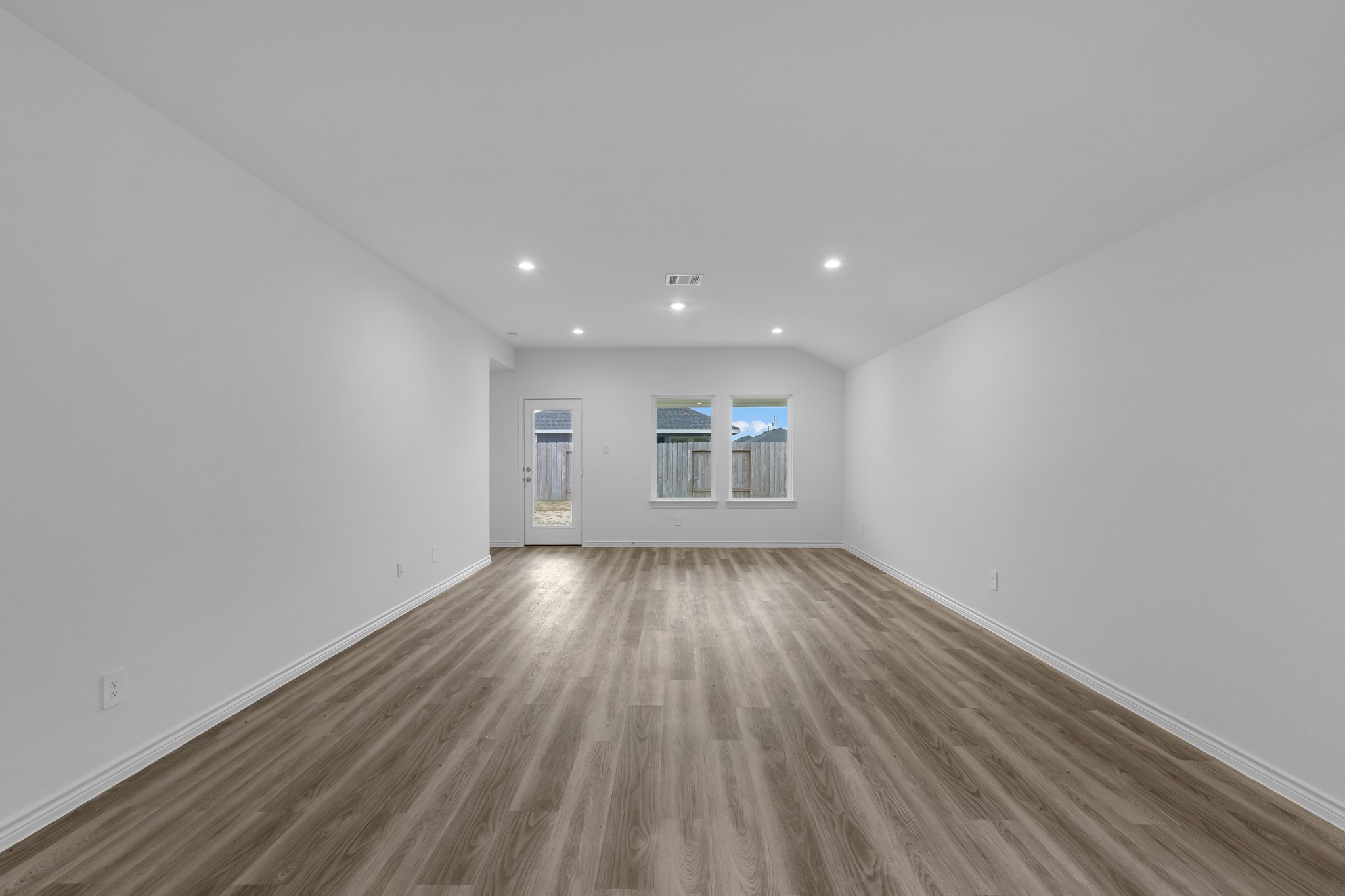 5650 Spoonbill Orange, TX 77632 - Photo 7 of 26 a view of an empty room with wooden floor and a window