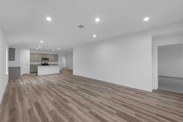 a view of kitchen with kitchen island sink and wooden floor