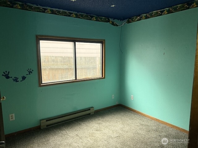 314 Liberty Avenue Granger, WA 98932 - Photo 17 of 26 a view of an empty room with a window and a ceiling fan
