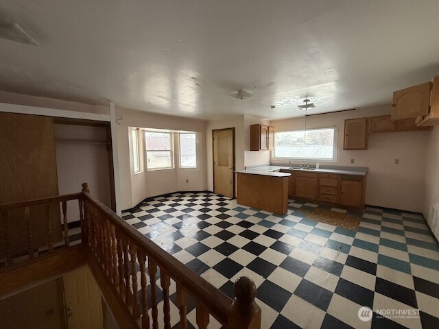314 Liberty Avenue Granger, WA 98932 - Photo 23 of 26 a kitchen with a checkered floor and white cabinets