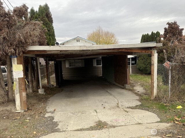 314 Liberty Avenue Granger, WA 98932 - Photo 3 of 26 a view of a house with a backyard and trees