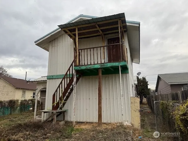 a view of a house with wooden fence