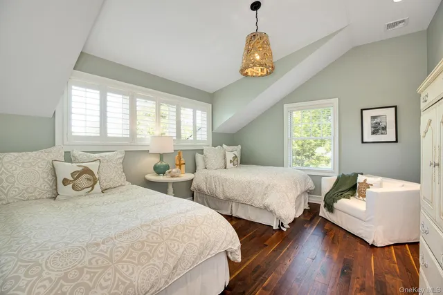 a bedroom with two beds and a table