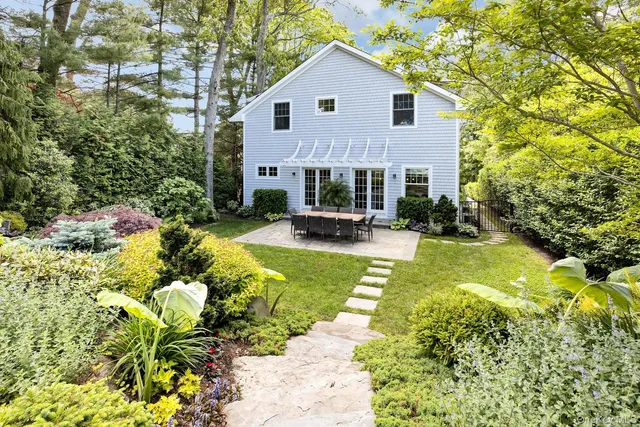 a view of a house with a yard and sitting area