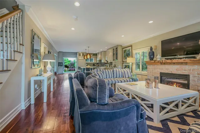 a living room with furniture fireplace and flat screen tv