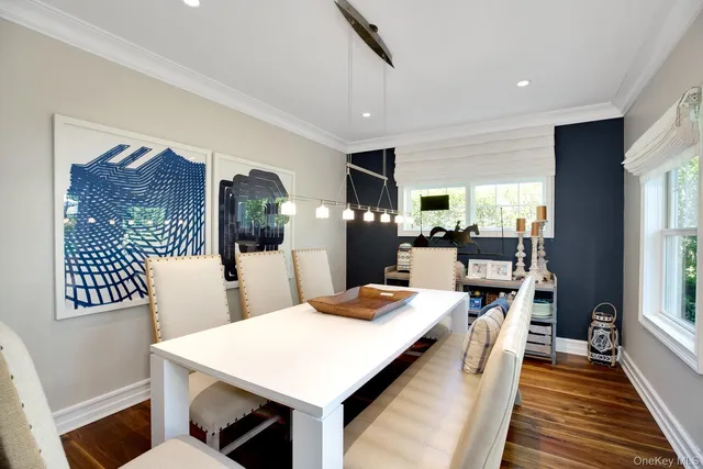 a large kitchen with sink a refrigerator and chairs
