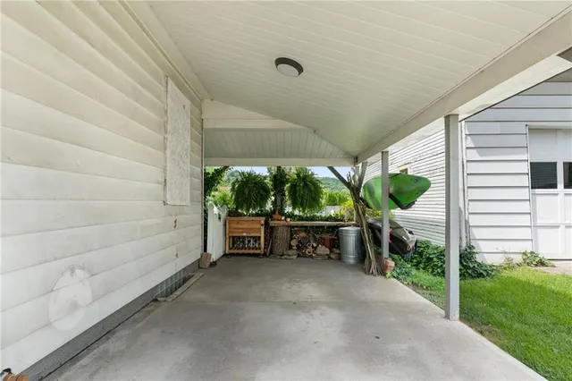 a view of a patio with table and chairs and potted plants