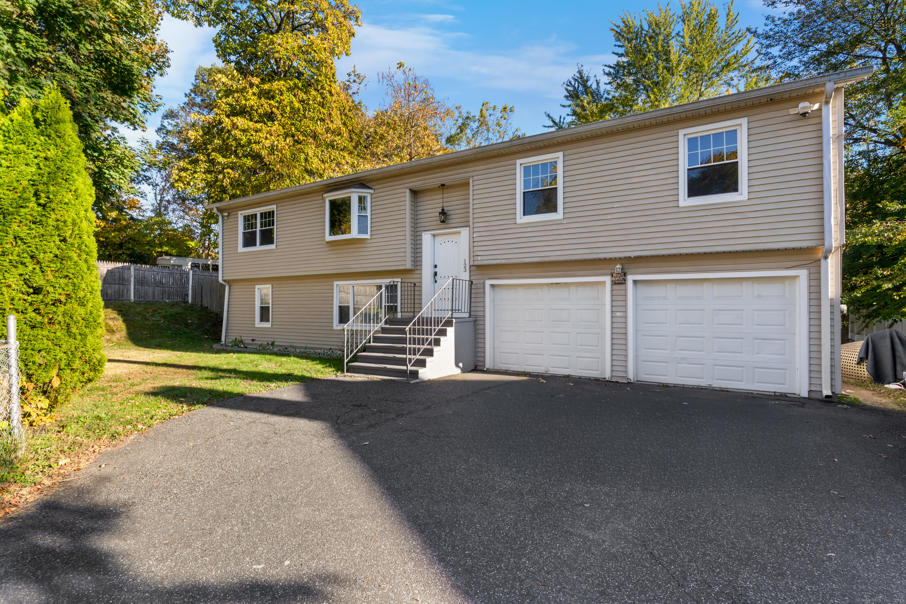 123 Exeter Street Bridgeport, CT 06606 - Photo 1 of 26 a view of a house with a yard and a large tree
