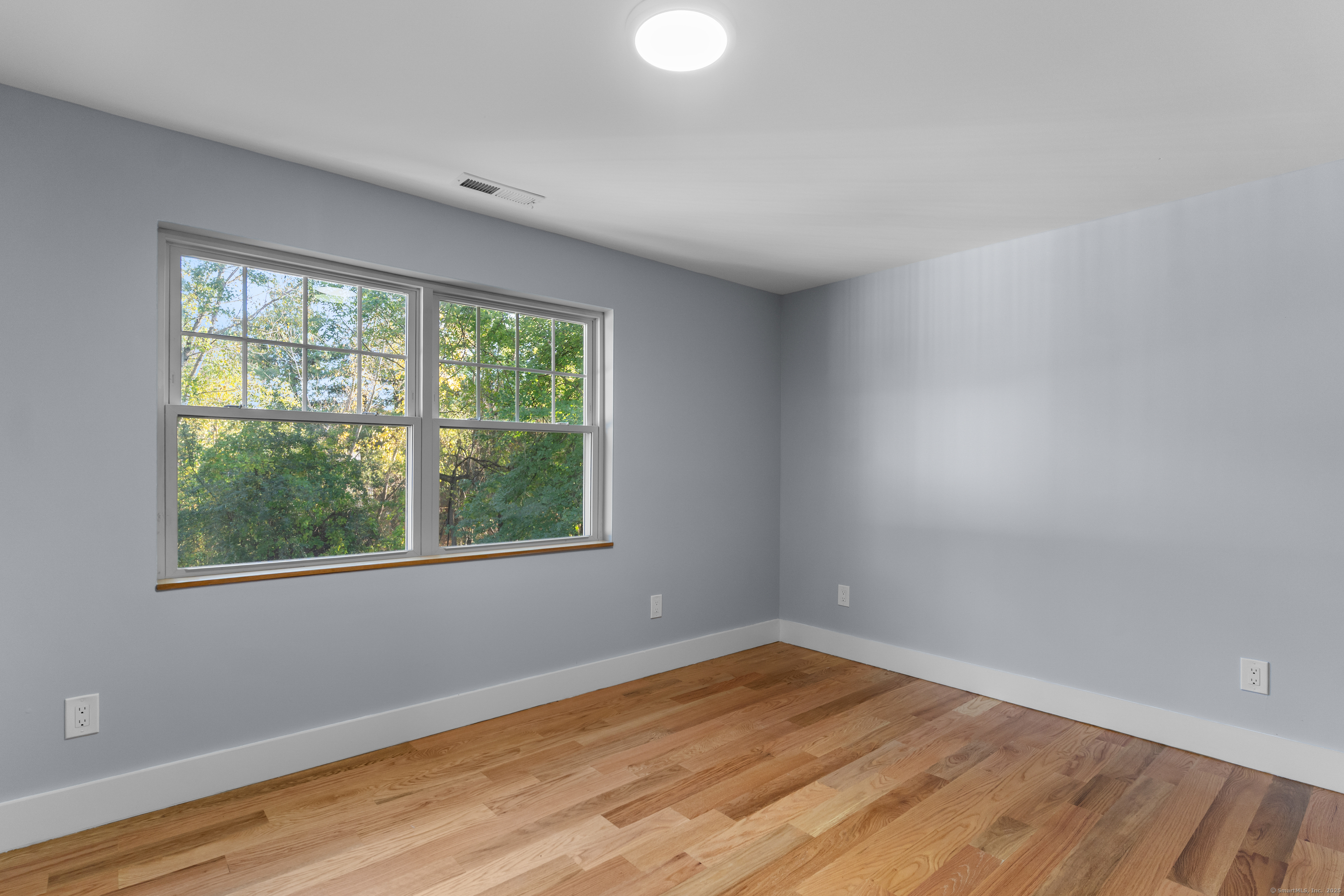 123 Exeter Street Bridgeport, CT 06606 - Photo 12 of 26 a view of an empty room with wooden floor and a window