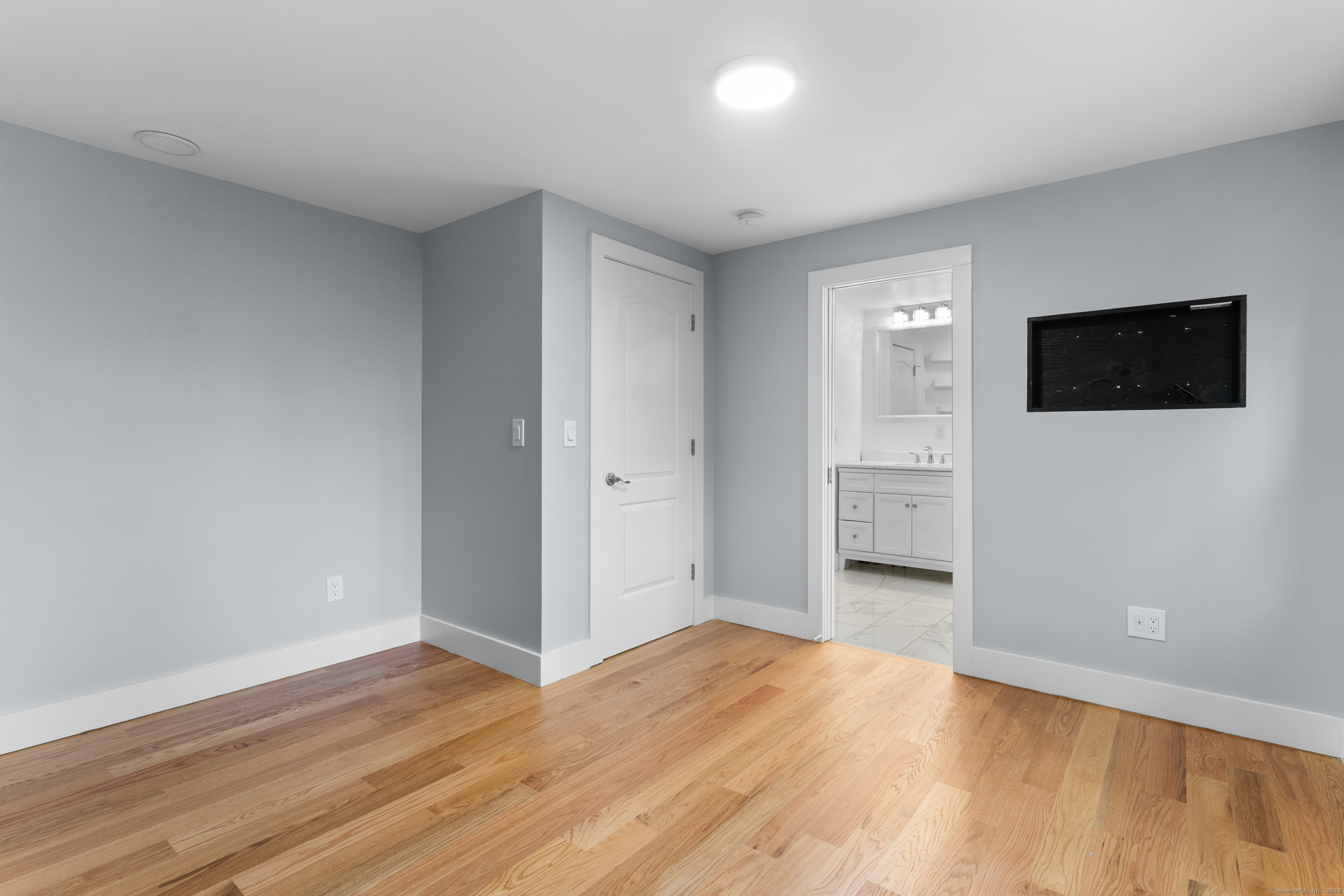 123 Exeter Street Bridgeport, CT 06606 - Photo 13 of 26 a view of a livingroom with wooden floor and a flat screen tv