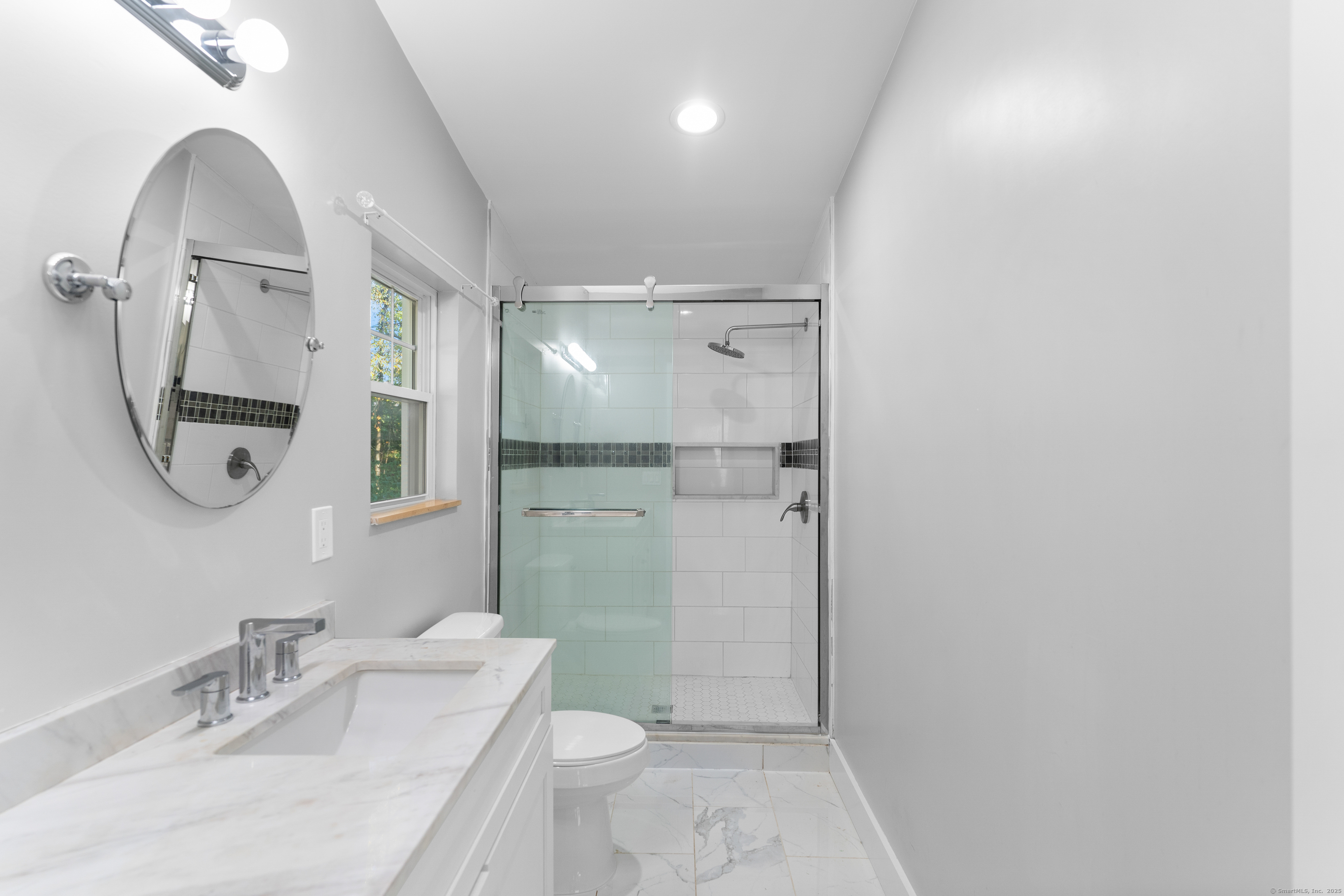 123 Exeter Street Bridgeport, CT 06606 - Photo 16 of 26 a bathroom with a granite countertop sink a toilet and a mirror