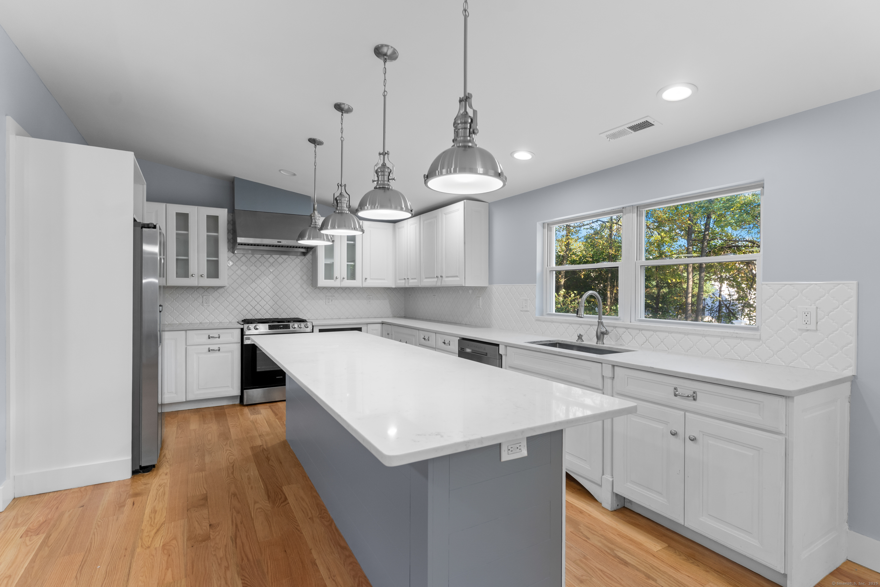 123 Exeter Street Bridgeport, CT 06606 - Photo 7 of 26 a large kitchen with stainless steel appliances a large center island attached withe living room