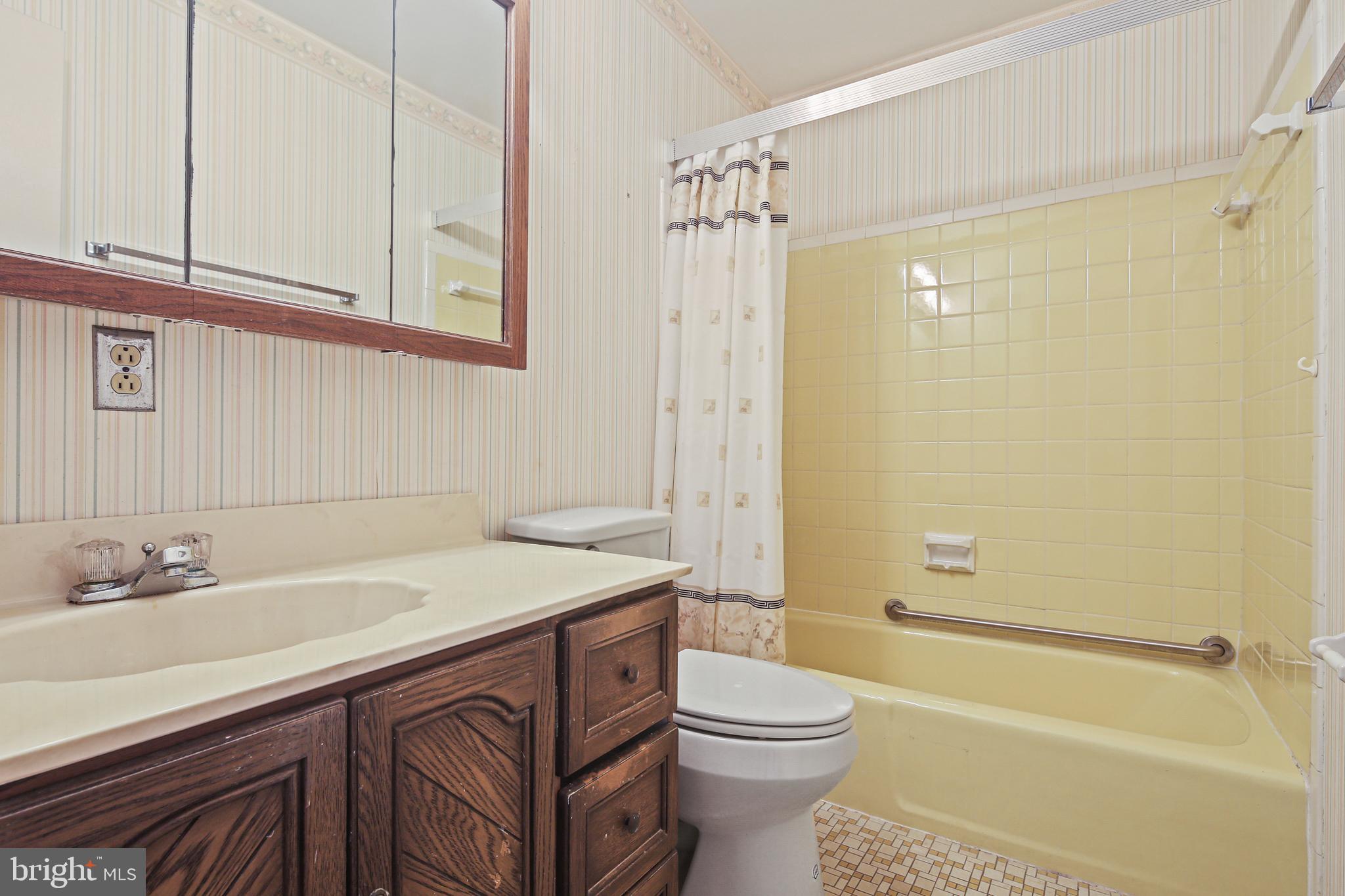 6215 Roblynn Road Laurel, MD 20707 - Photo 22 of 38 a bathroom with a sink a toilet and shower