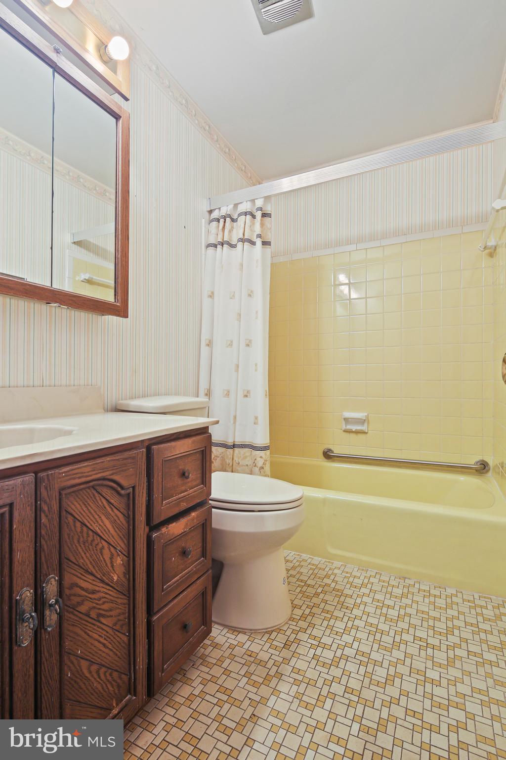 6215 Roblynn Road Laurel, MD 20707 - Photo 23 of 38 a bathroom with a sink a toilet and shower