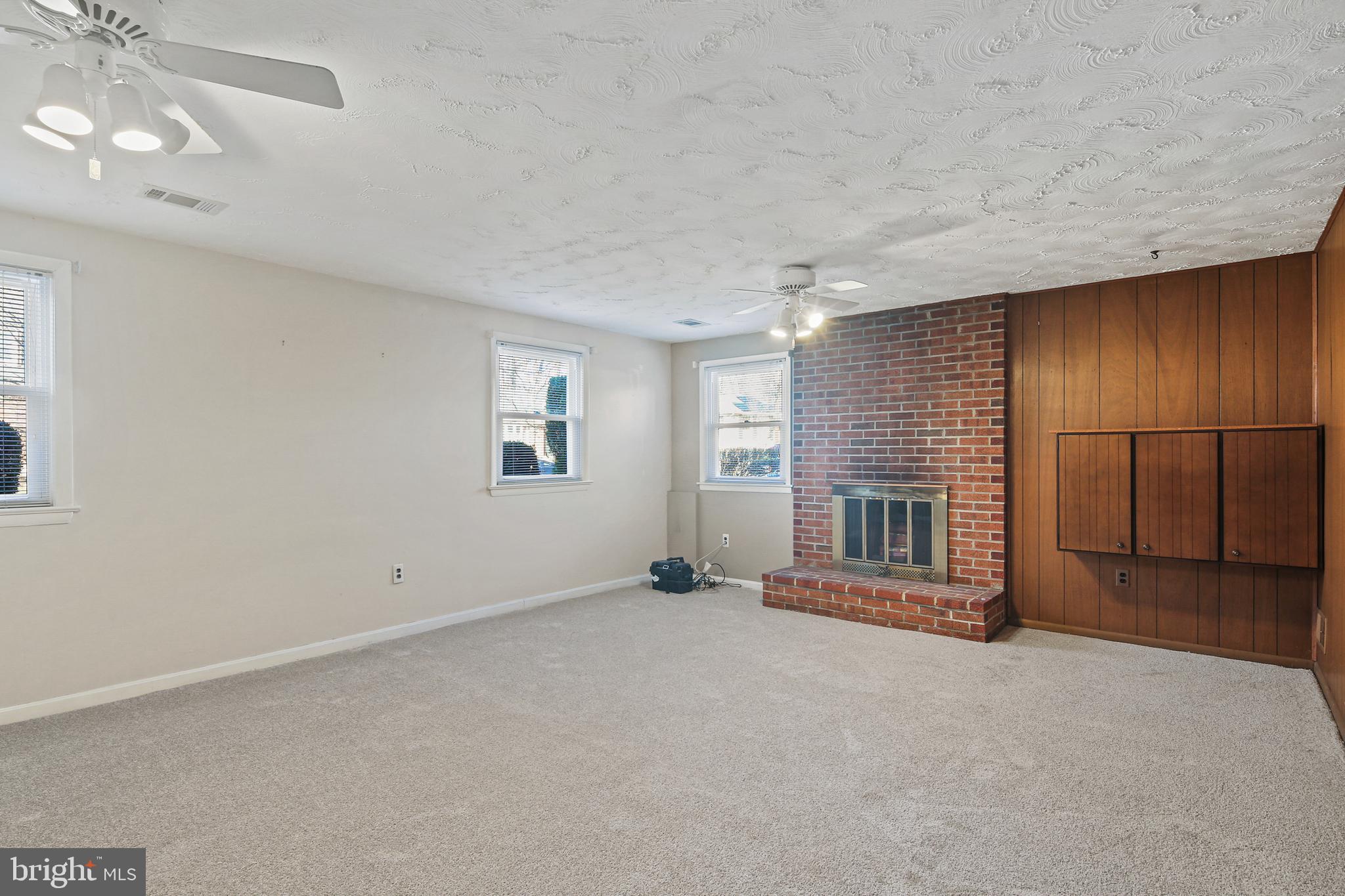 6215 Roblynn Road Laurel, MD 20707 - Photo 24 of 38 an empty room with fireplace and windows