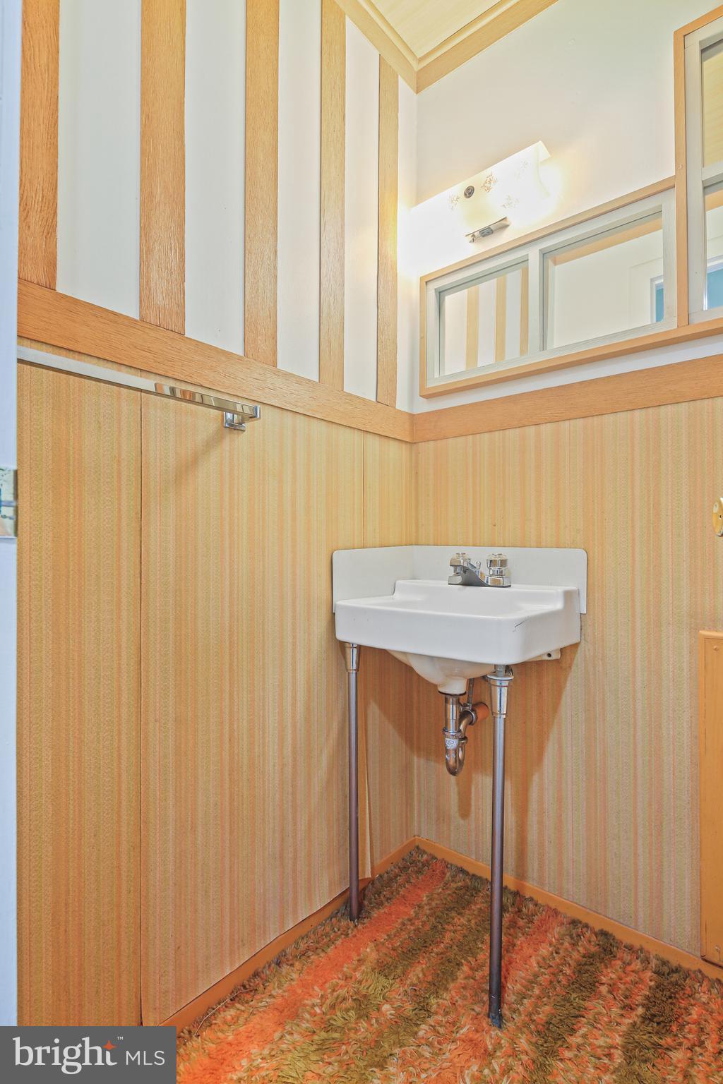 6215 Roblynn Road Laurel, MD 20707 - Photo 32 of 38 a bathroom with a sink and a mirror