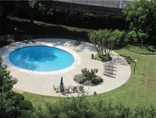 a living room with furniture potted plant and a flat screen tv