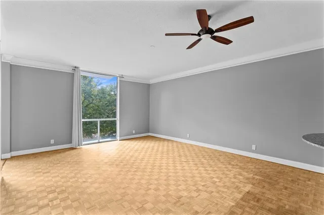 wooden floor in an empty room with a window